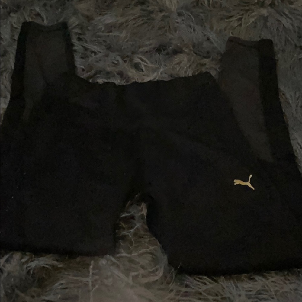 Puma leggings that are black with gold logo.